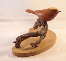 Carved Goldcrest in Yew on Oak base and natural Branch